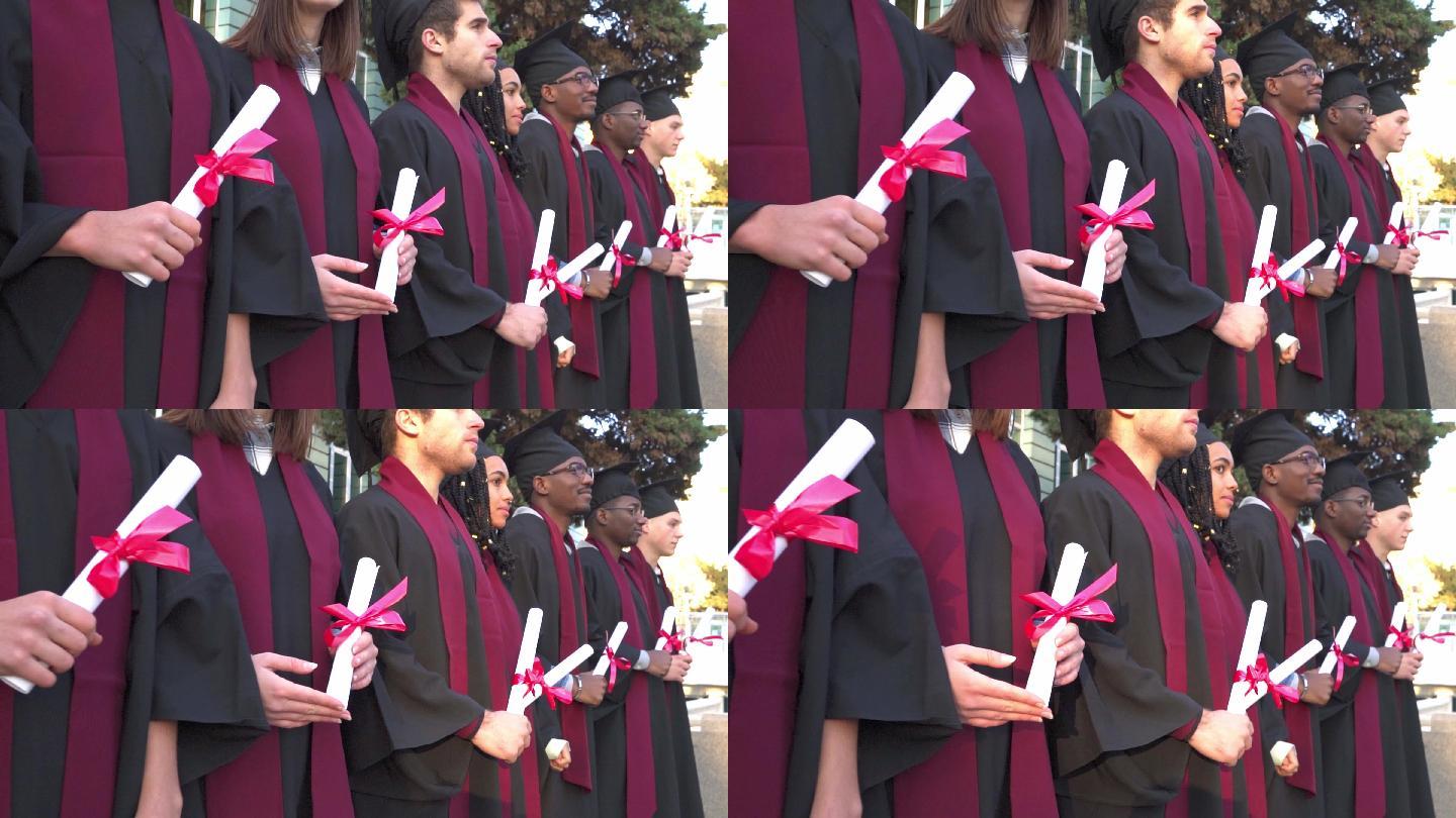 毕业生穿着长袍和灰泥板站成一排