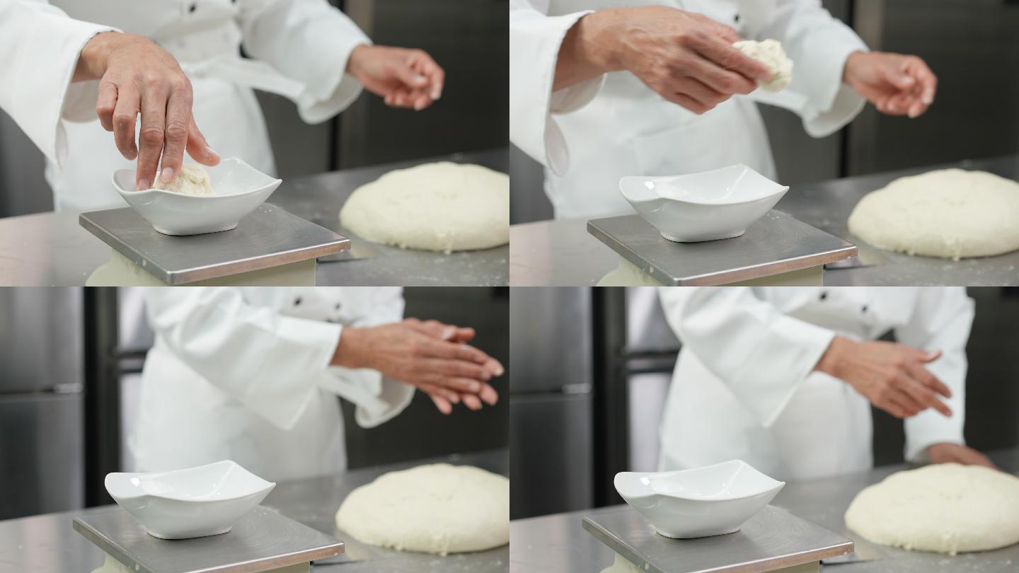 特写镜头：白色厨师揉捏和准备面团，在成型前分割和称重，在商业面包房厨房制作面包和馒头