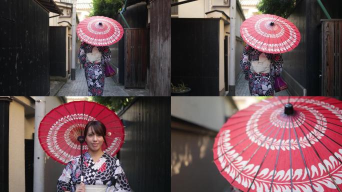 在Yukata的日本妇女在狭窄的小路上行走-使用纸伞