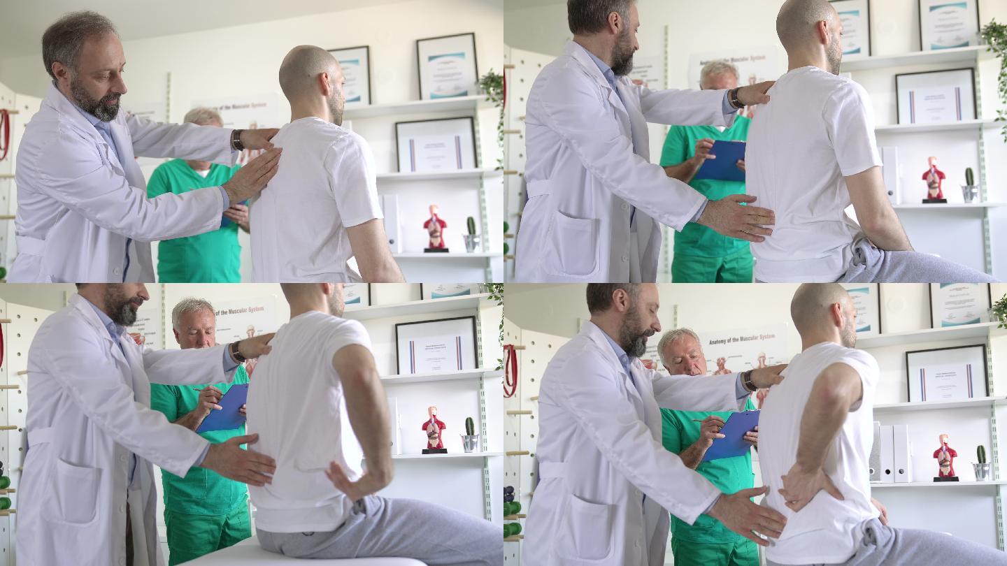 物理治疗师和他的助手在医生办公室与老年患者谈论背部受伤的情况