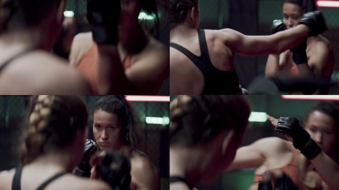 女子MMA拳击手训练。眼神交流和打孔