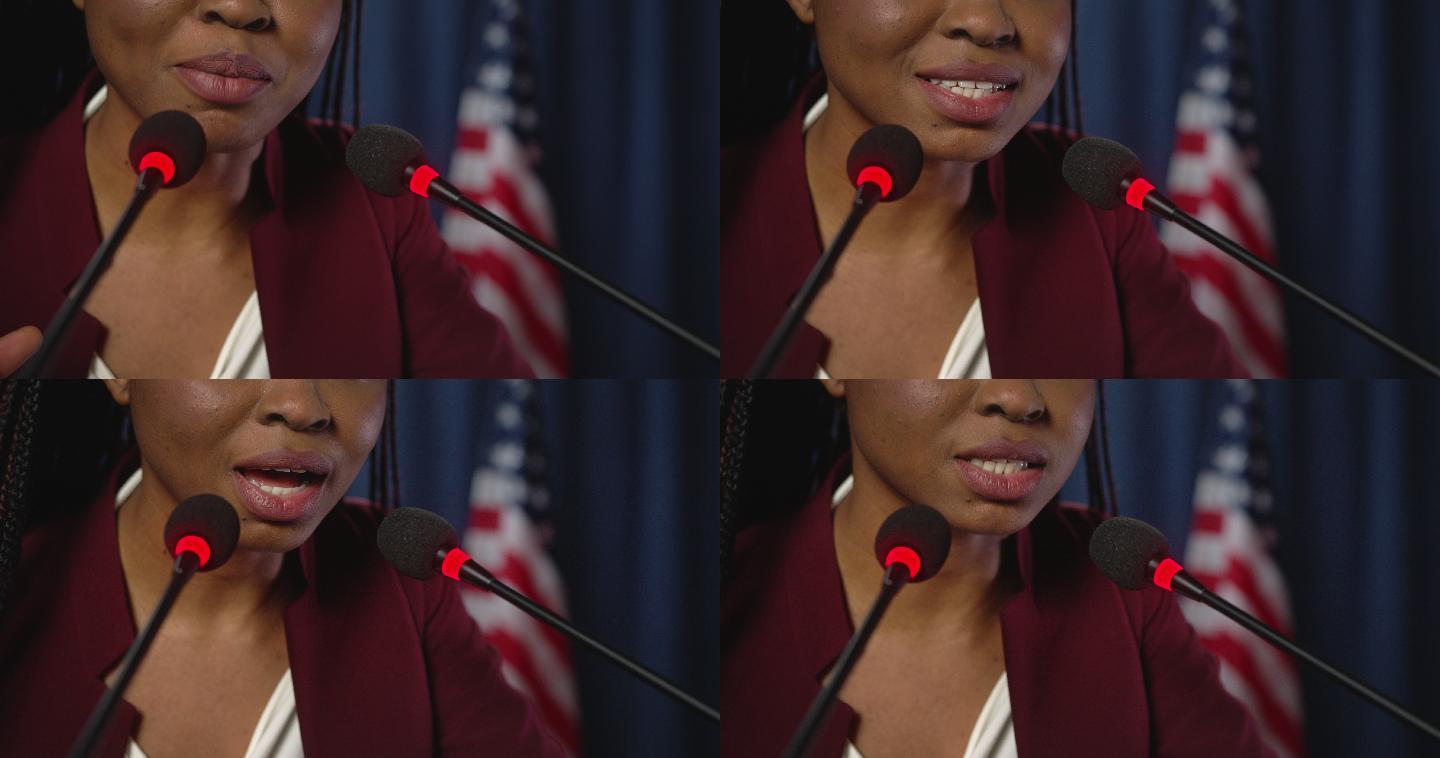 年轻的非裔美国政治家以美国国旗为背景发表演讲