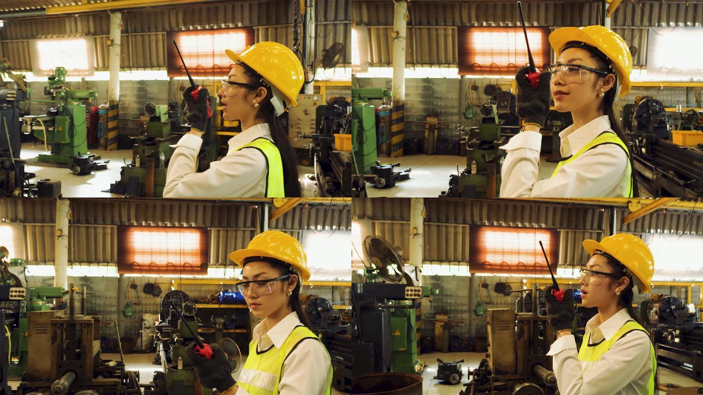 工程师们正在为工业工人使用机器。戴着安全帽和反光背心的亚洲男女工人在工厂工作。对讲机工人在工厂走路时