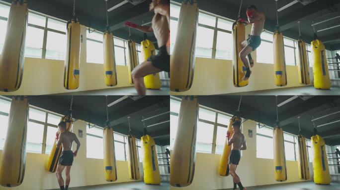 慢动作亚洲马来泰拳拳击手在健身房健身俱乐部飞踢拳击袋