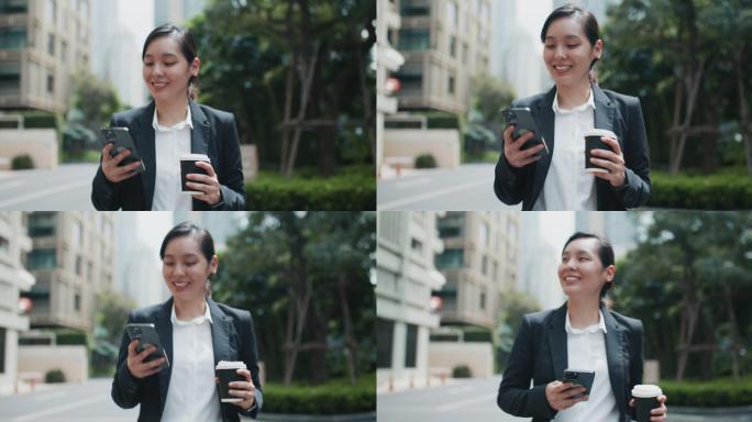 亚洲女商人拿着咖啡杯走路时使用智能手机