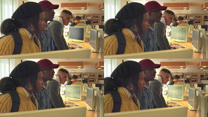 一对非裔美国人夫妇正在电脑房里仔细地听他们的朋友讲话