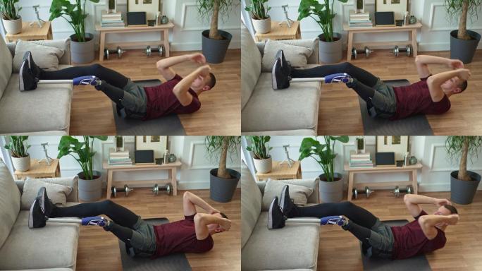 带假肢的年轻人在家里瑜伽垫上做仰卧起坐练习