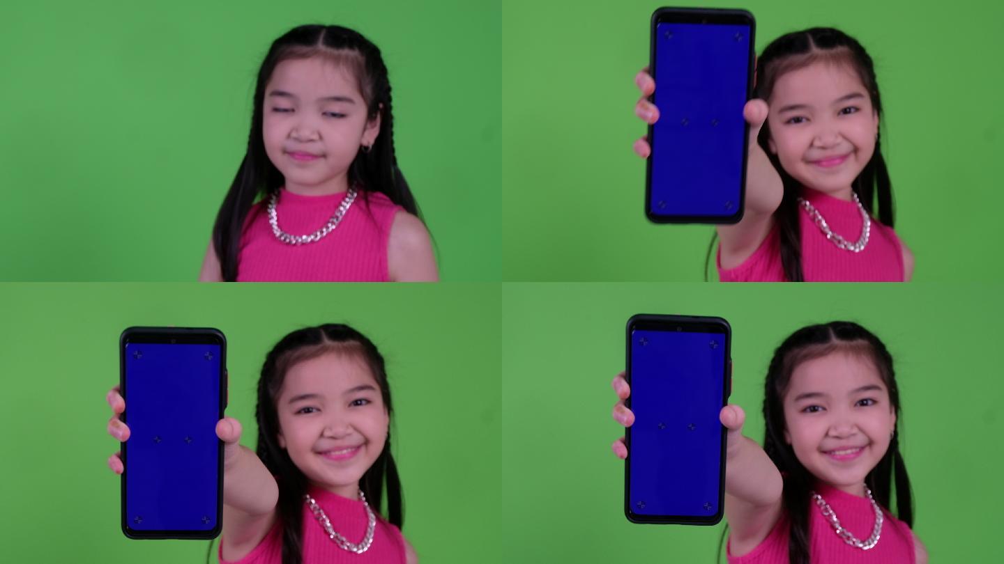 女孩在绿色屏幕上手持智能手机