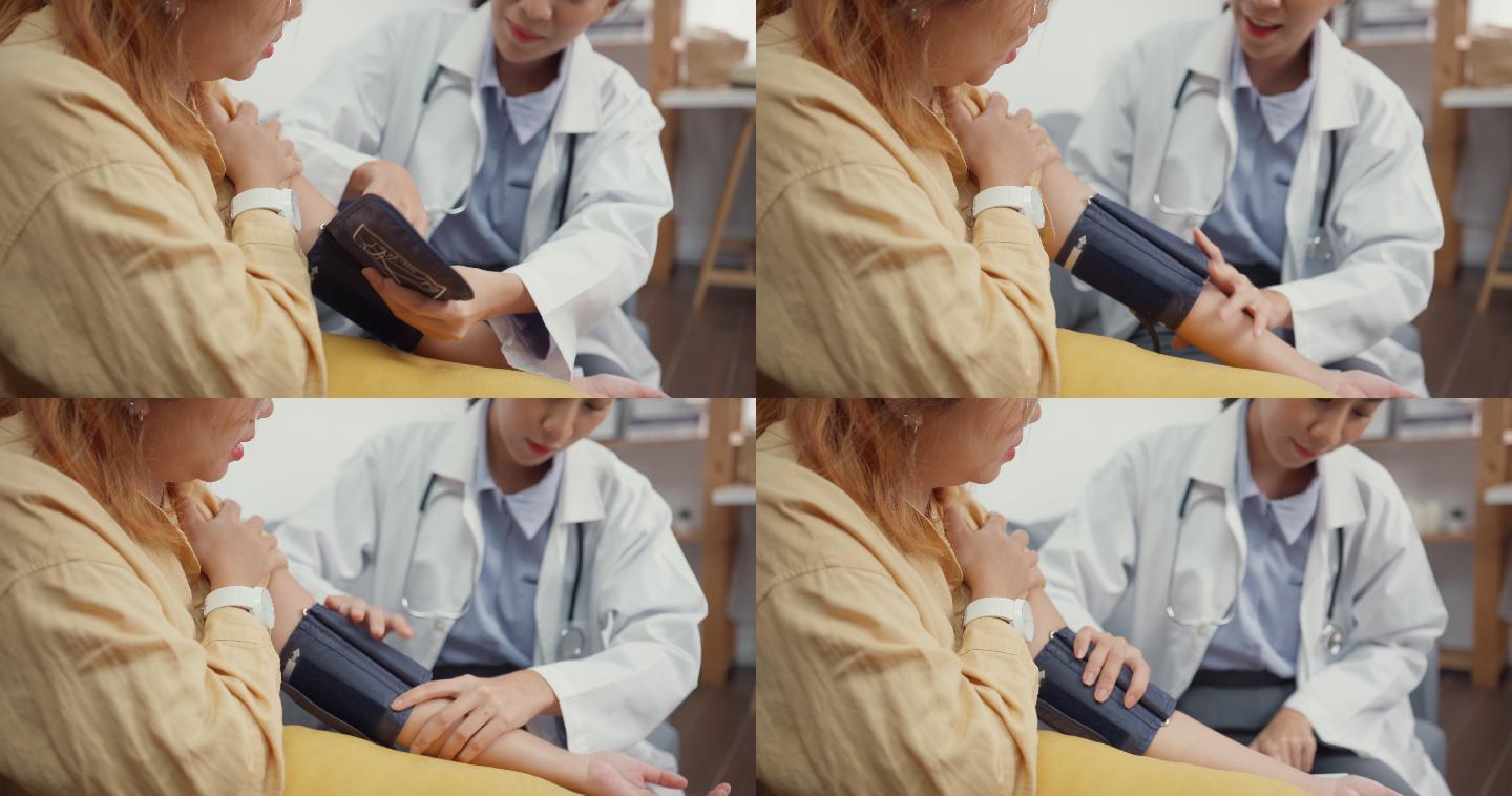 亚洲女医生在家和病人一起测量血压。特写镜头。