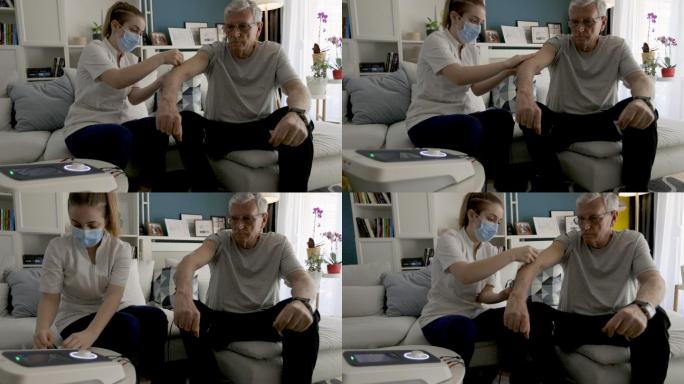 物理治疗师正在对一名老年男子的肘部进行物理治疗中的电刺激