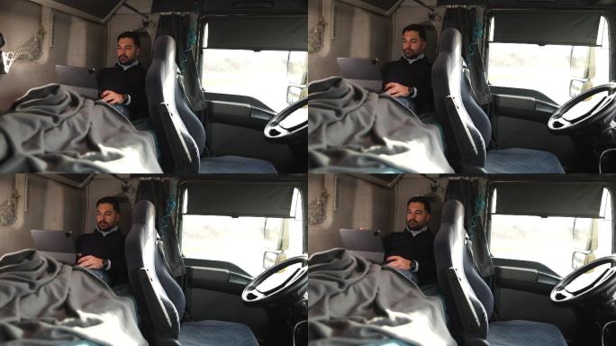 卡车司机躺在驾驶室床上使用平板电脑