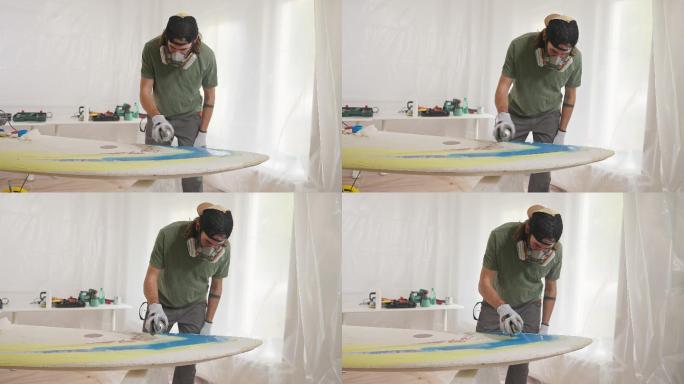 男子喷漆冲浪板上色颜色油漆