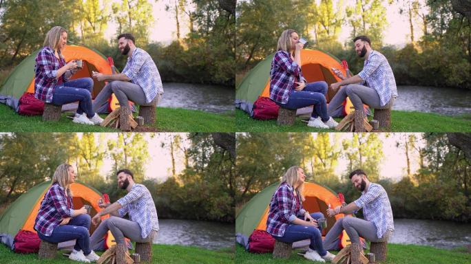 夫妇在河边露营，喝咖啡