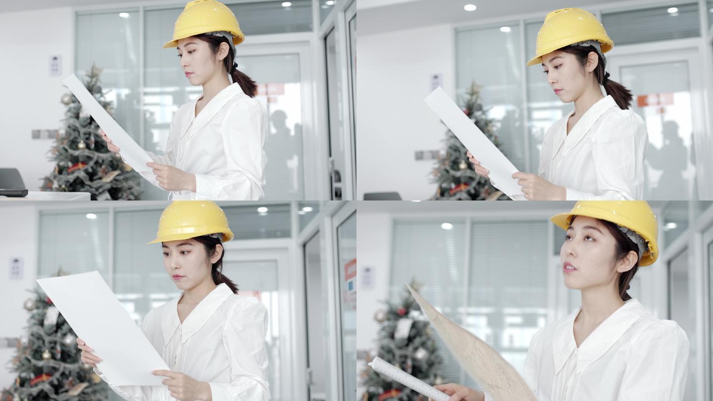 年轻漂亮的亚洲女工程师，戴着黄色头盔，用对讲机与团队成员交谈