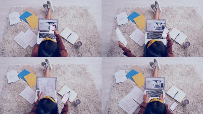 从上方拍摄的一段4k视频，一个面目全非的女孩在家的地板上完成文书工作