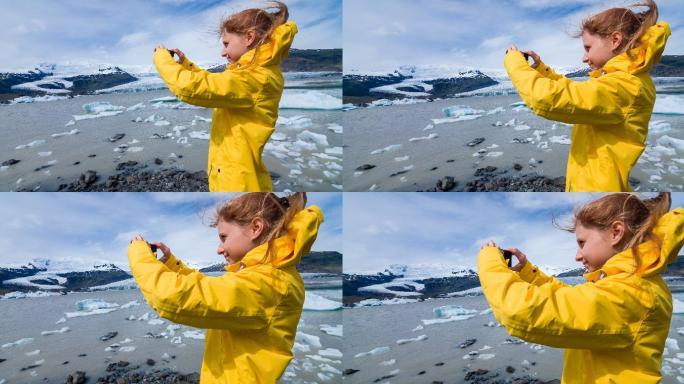 大风天，一名女子在冰河泻湖拍摄浮冰照片