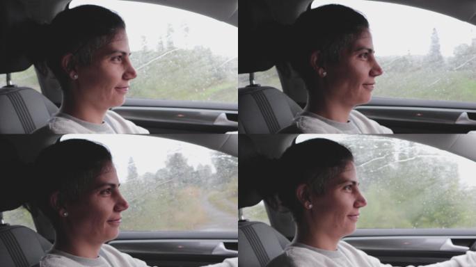 雨天开车的自信快乐的女人