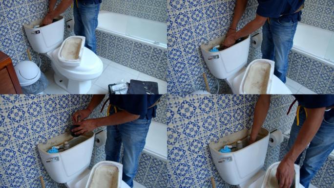 无法辨认的管道工在客户家中的浴室修理厕所