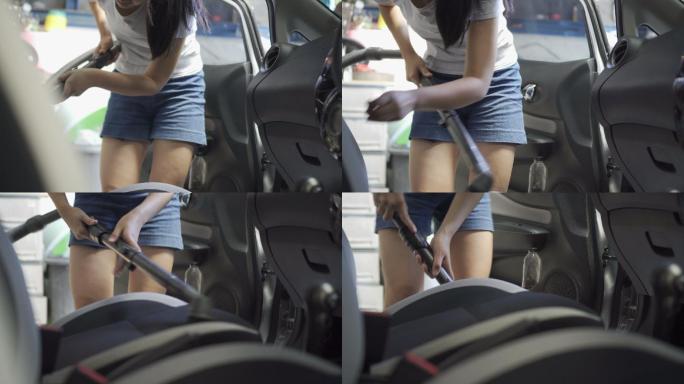 亚洲少女用吸尘器清洁汽车