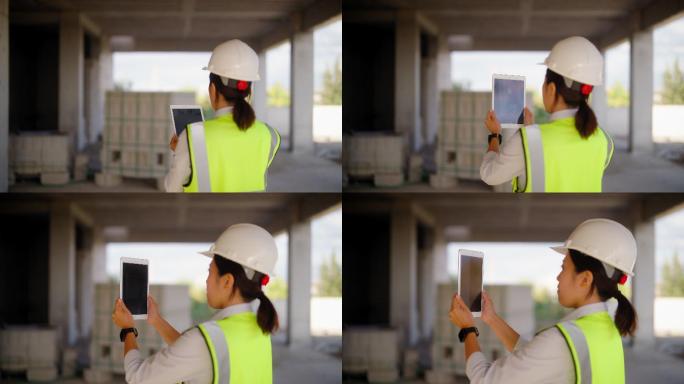 女工程师在施工现场使用数字平板电脑
