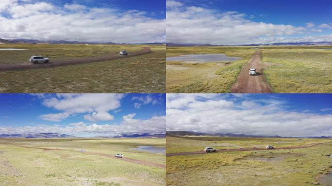 越野车行驶在西藏的草原土路上