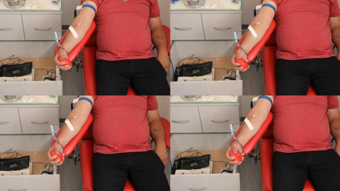 善行。为你的身体献血的好处。接受输血者的手。临床献血者的特写镜头
