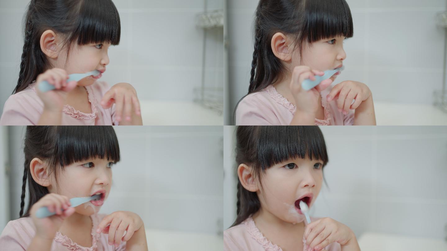 亚洲可爱的小女孩或小孩在浴室用牙刷刷牙。牙科卫生保健概念。