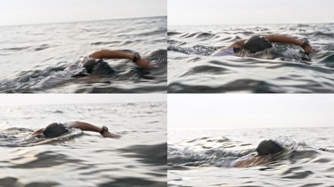 TS女子游泳运动员在海中向前爬行