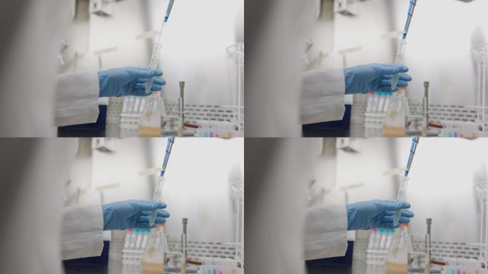 科学家在实验室用吸管取样