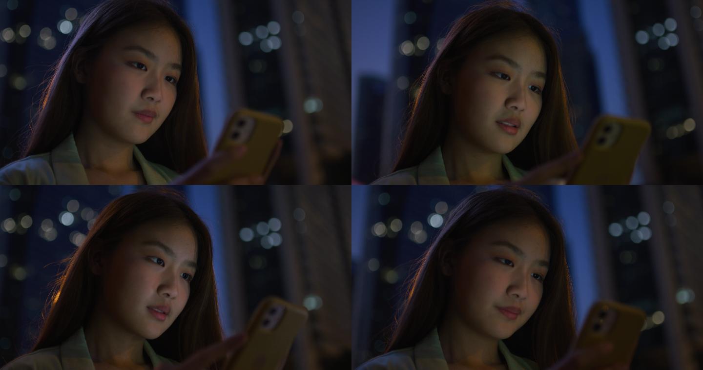 亚洲年轻女子晚上发手机短信
