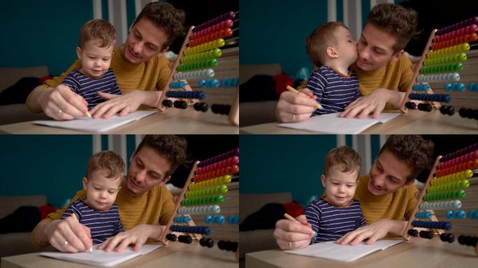 年轻的父亲教他的小男孩画画