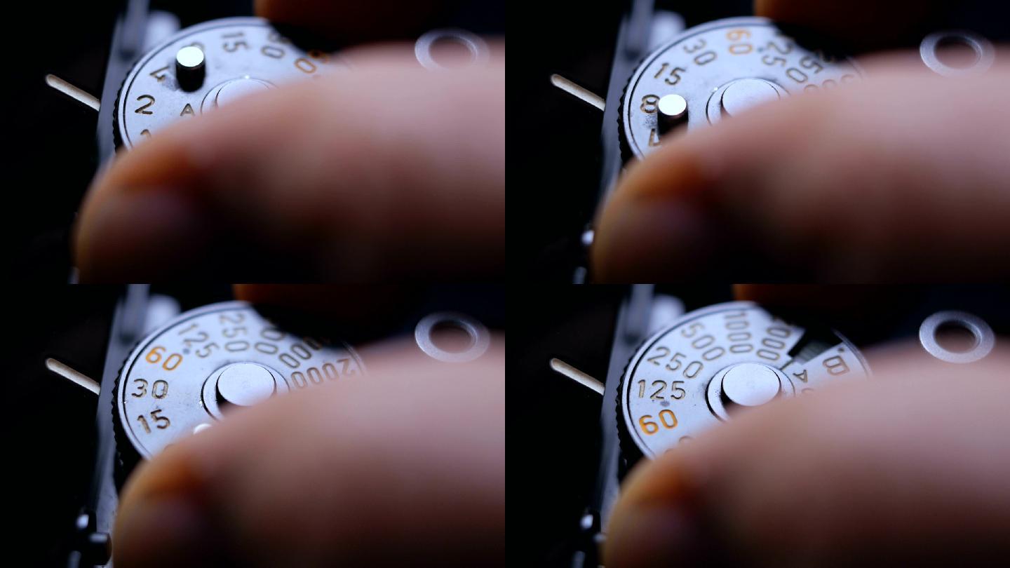 一台老式单反胶片相机的特写细节和手指调节曝光速度刻度盘时发出的咔嗒声