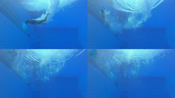 一名女子跳水运动员在游泳池着陆的LD水下视图