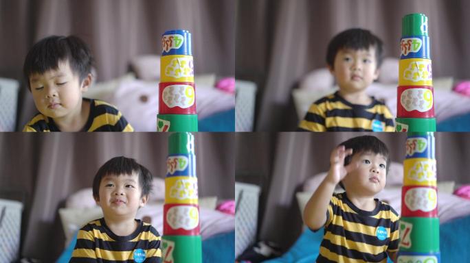 亚洲小男孩在家玩叠杯