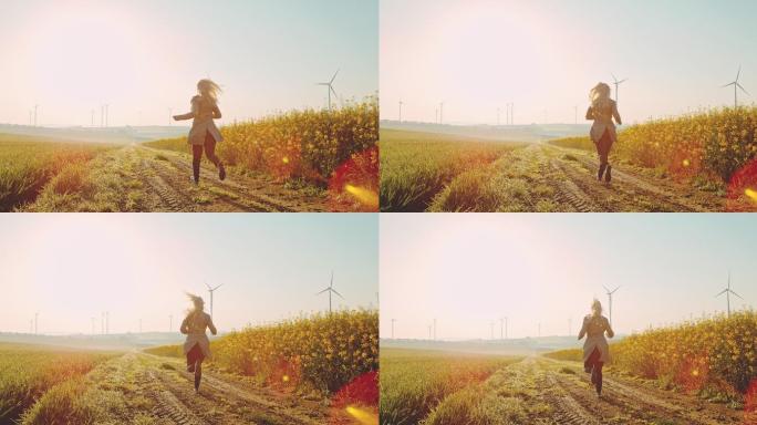 超级慢-时间扭曲效应女子在油菜田上奔跑，远处有风力涡轮机