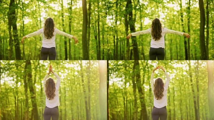 斯洛莫年轻女子在阳光明媚的森林里做呼吸练习