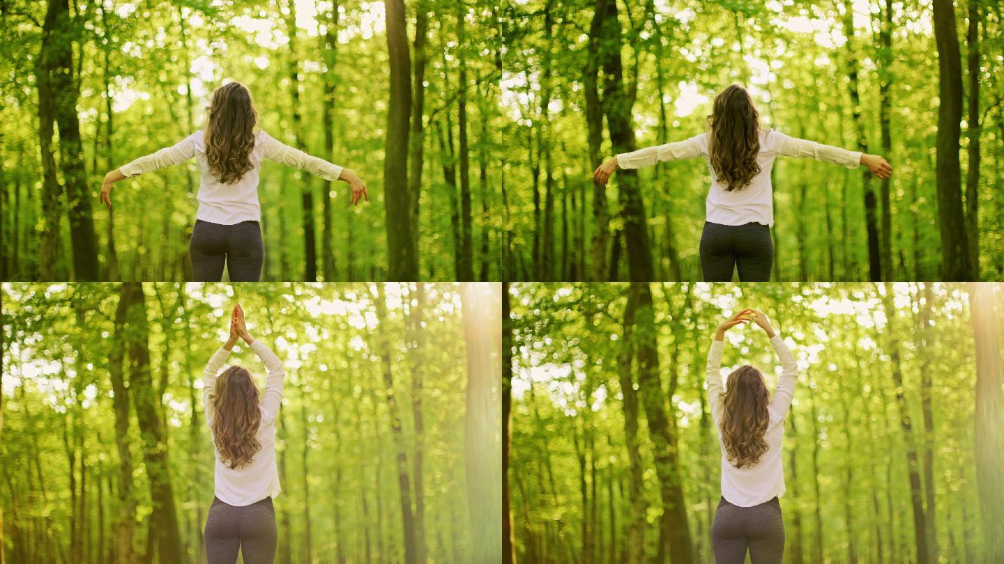 斯洛莫年轻女子在阳光明媚的森林里做呼吸练习