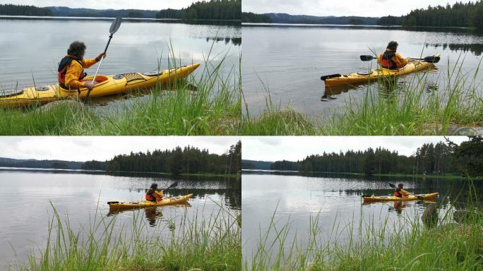 那个人在山湖里划独木舟。划船和生态旅游。