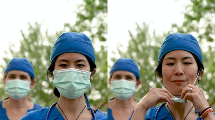 微笑的亚裔和白种人医护人员戴着防护面罩