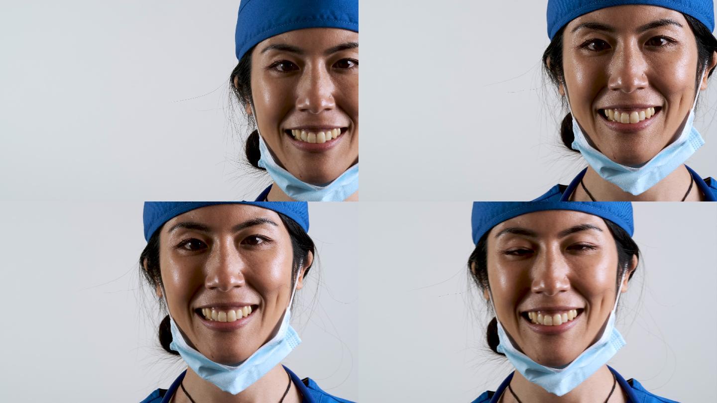 微笑的亚洲中年保健工作者看着摄像机