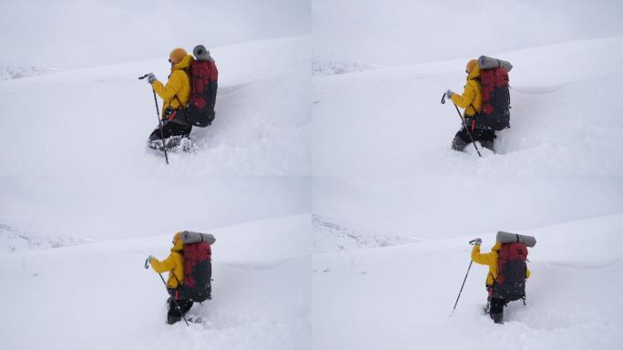 冬天背着背包在山上徒步旅行的男人