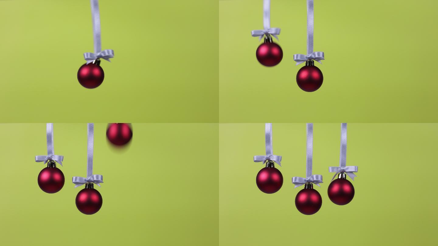 三个圣诞装饰球一个接一个落下