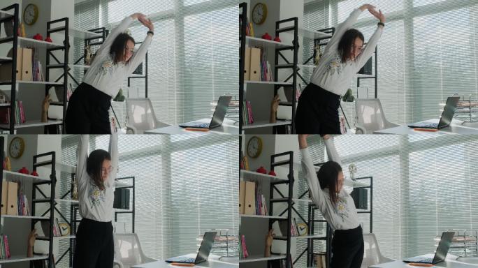 女性在办公室工作时伸展身体