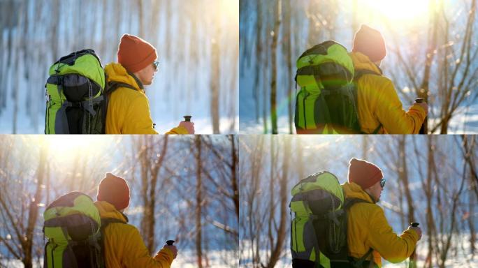 冬天背着背包在山上徒步旅行的男人