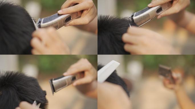 covid-19冠状病毒情况下女性在家用剪子手工理发的特写镜头