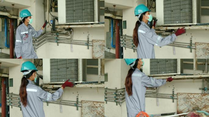 亚洲女技术员检查员检查建筑物内的空调泄漏。工程师女性触摸