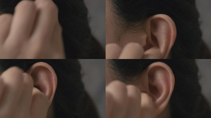 分辨率为4k的亚洲女性将手指伸进她发痒的耳朵。医疗保健和医疗概念。