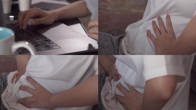 亚洲女性在家远程使用笔记本电脑时腹痛