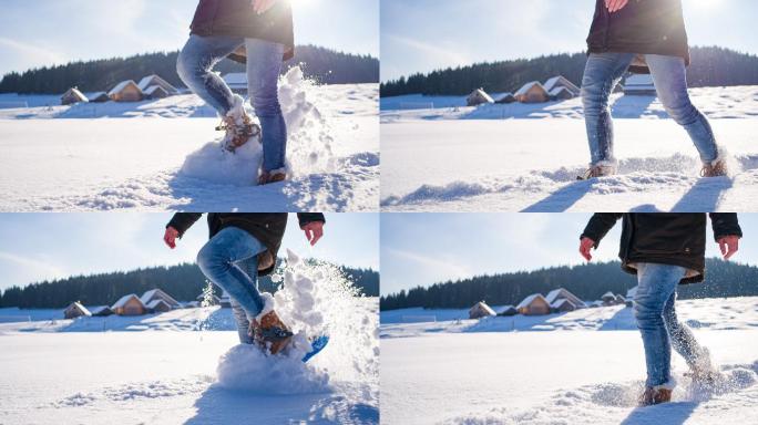 穿着雪鞋漫步在田园诗般的冰雪覆盖的冬季景观中