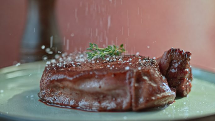 在牛排上撒盐牛肉美食